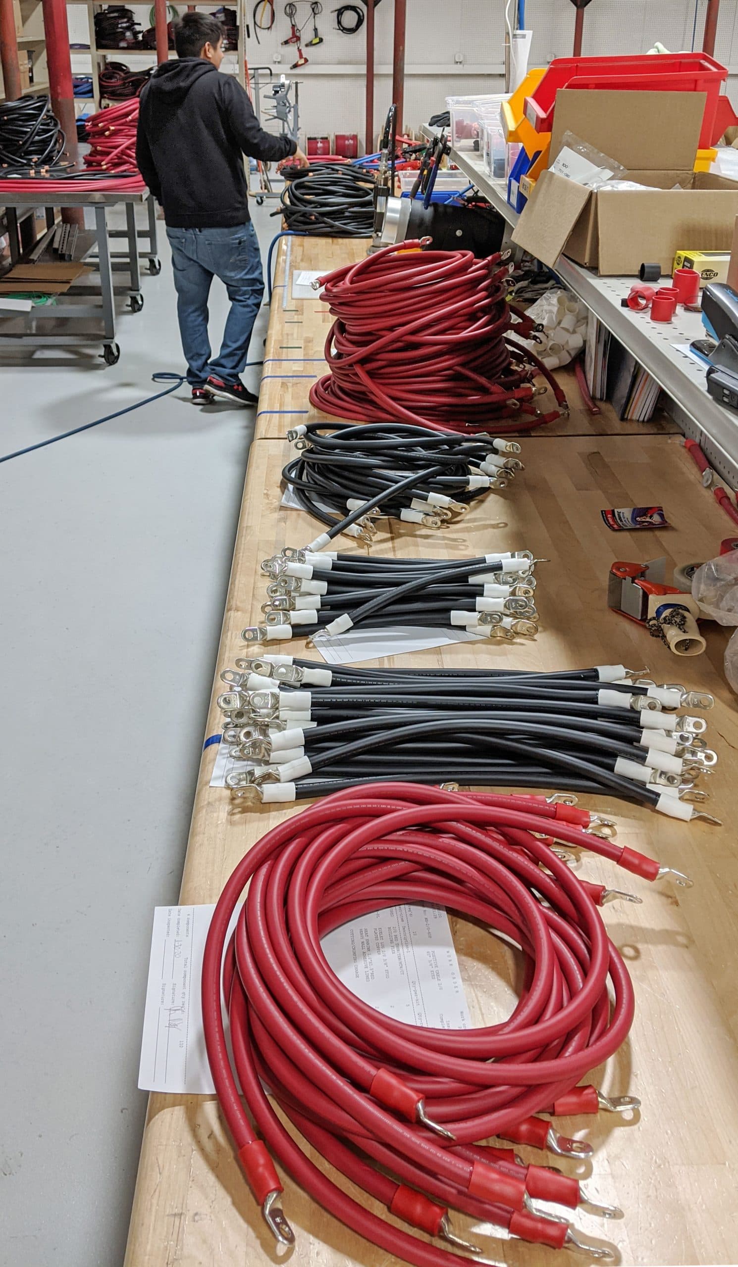 Blue battery interconnect cables beside a battery bank