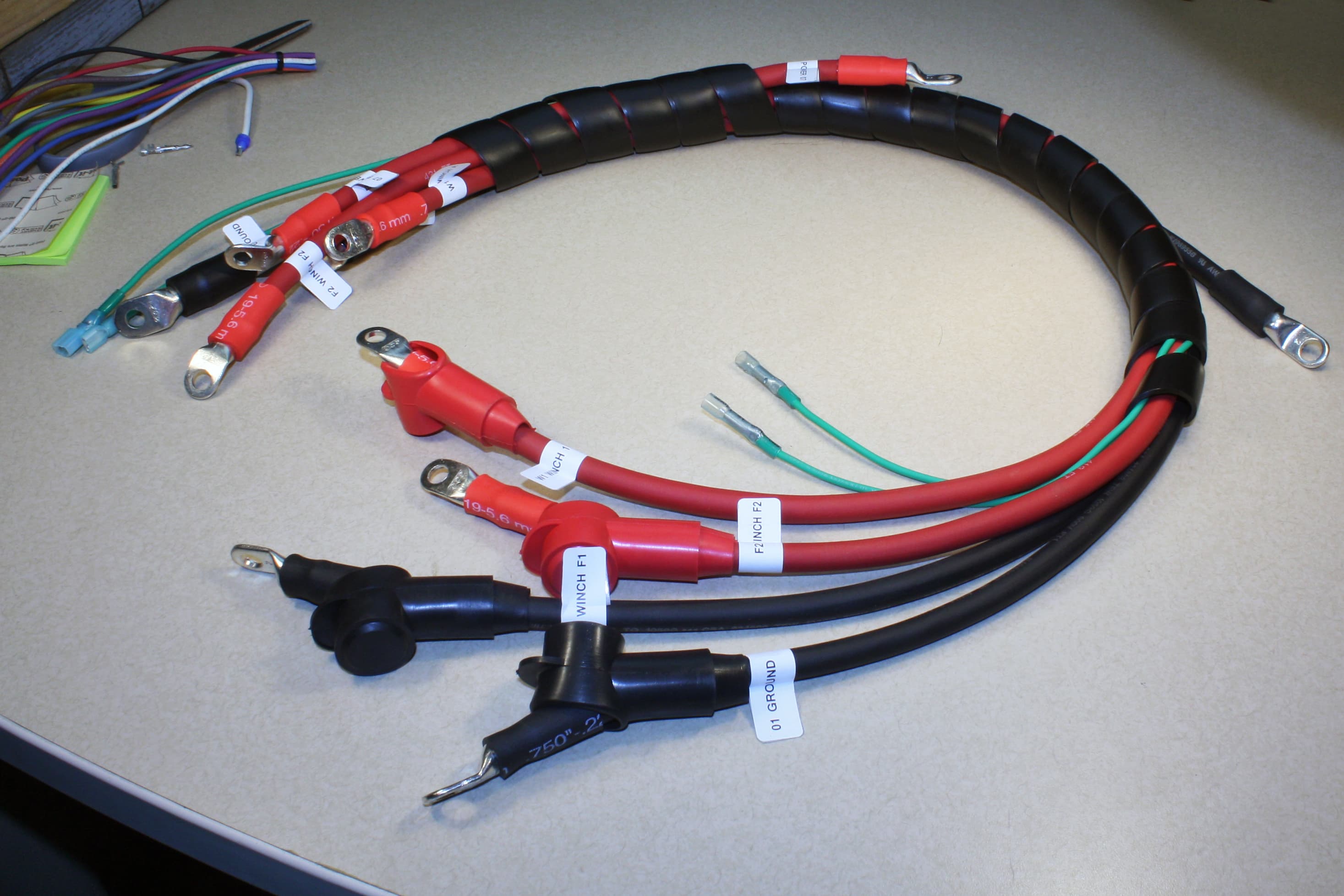 A finished harness in spiral loom with labeled, boot-covered lugs