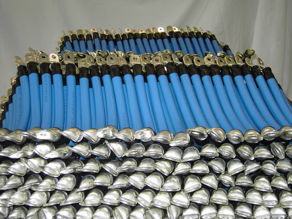 Rows of lugged battery and booster cables with heat shrink
