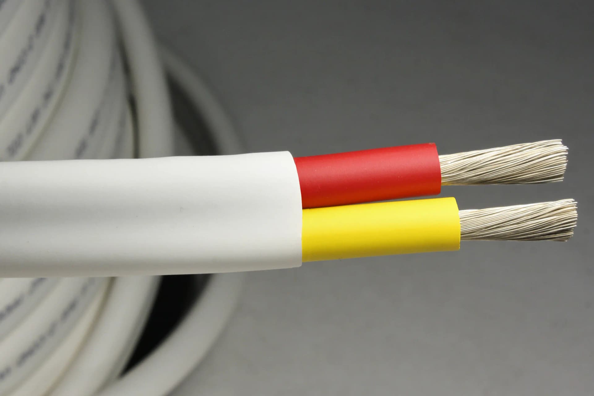 Flat yellow and red DC duplex boat cable with the jacket cut back