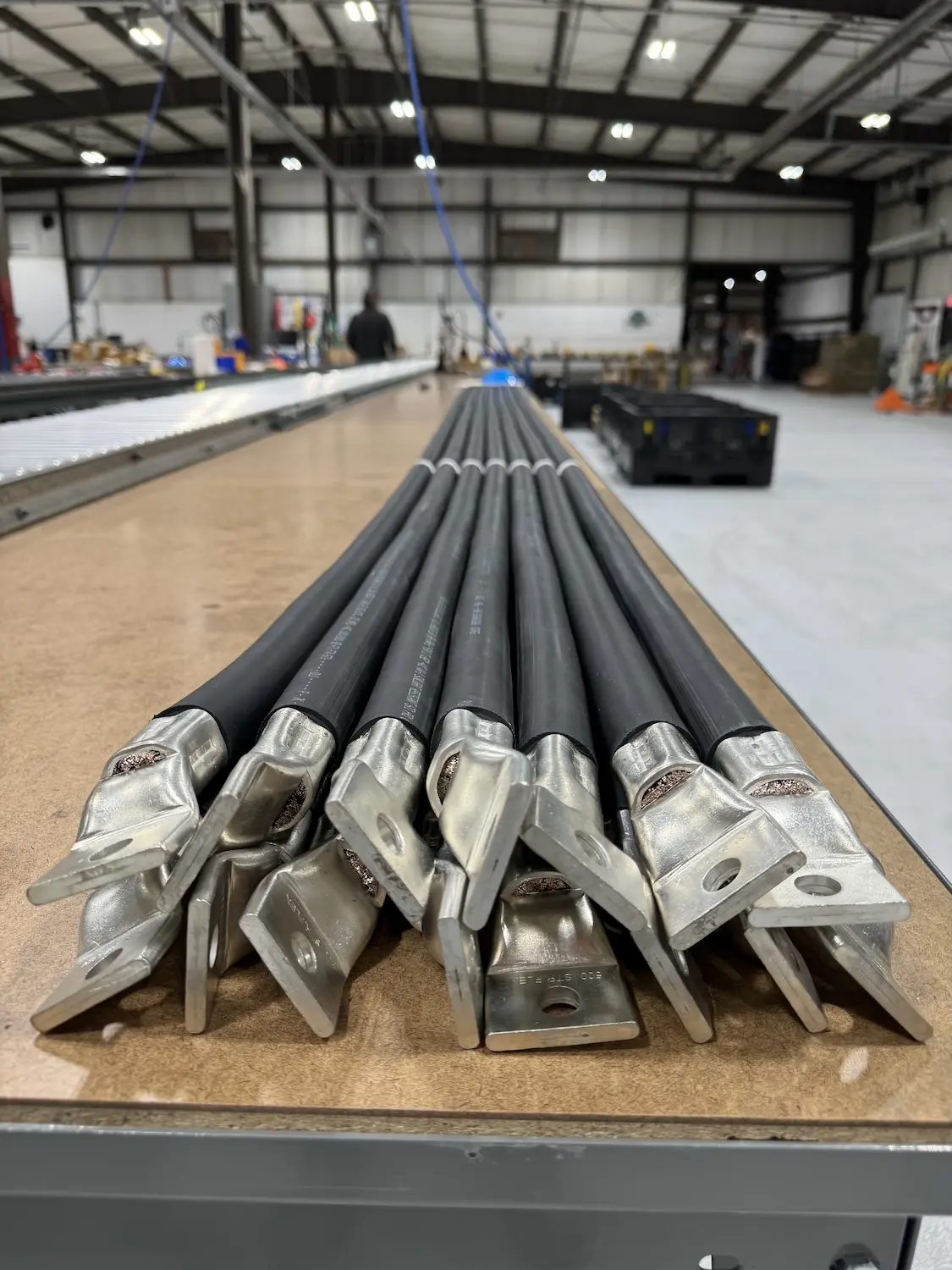DLO cables with bolted lugs laid out on a Polar Wire assembly table