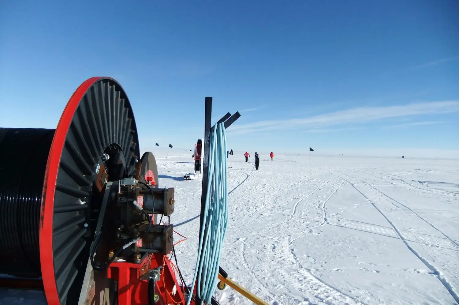 A cable reel and coiled cable on an arctic ice field