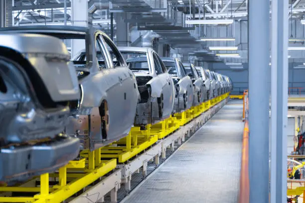 Vehicle bodies moving along an assembly line