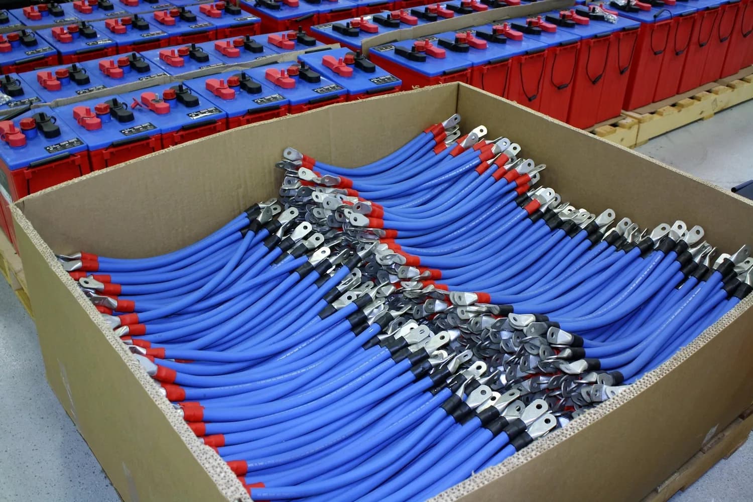 Battery connector cables stacked in a box