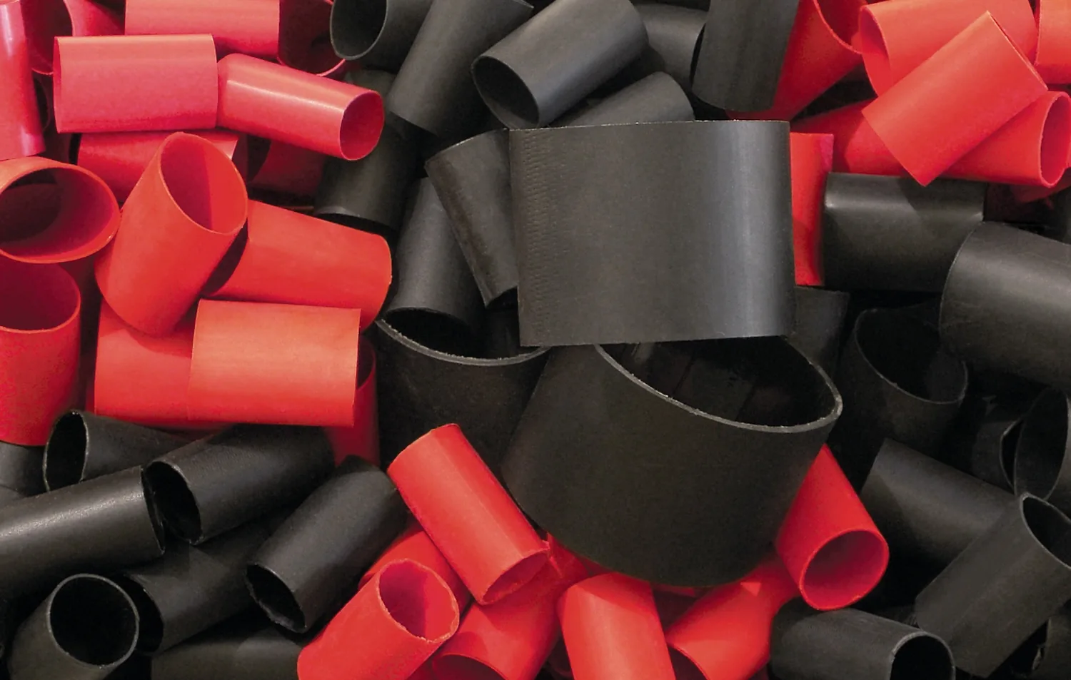 Precut adhesive-lined heat shrink piled on a table