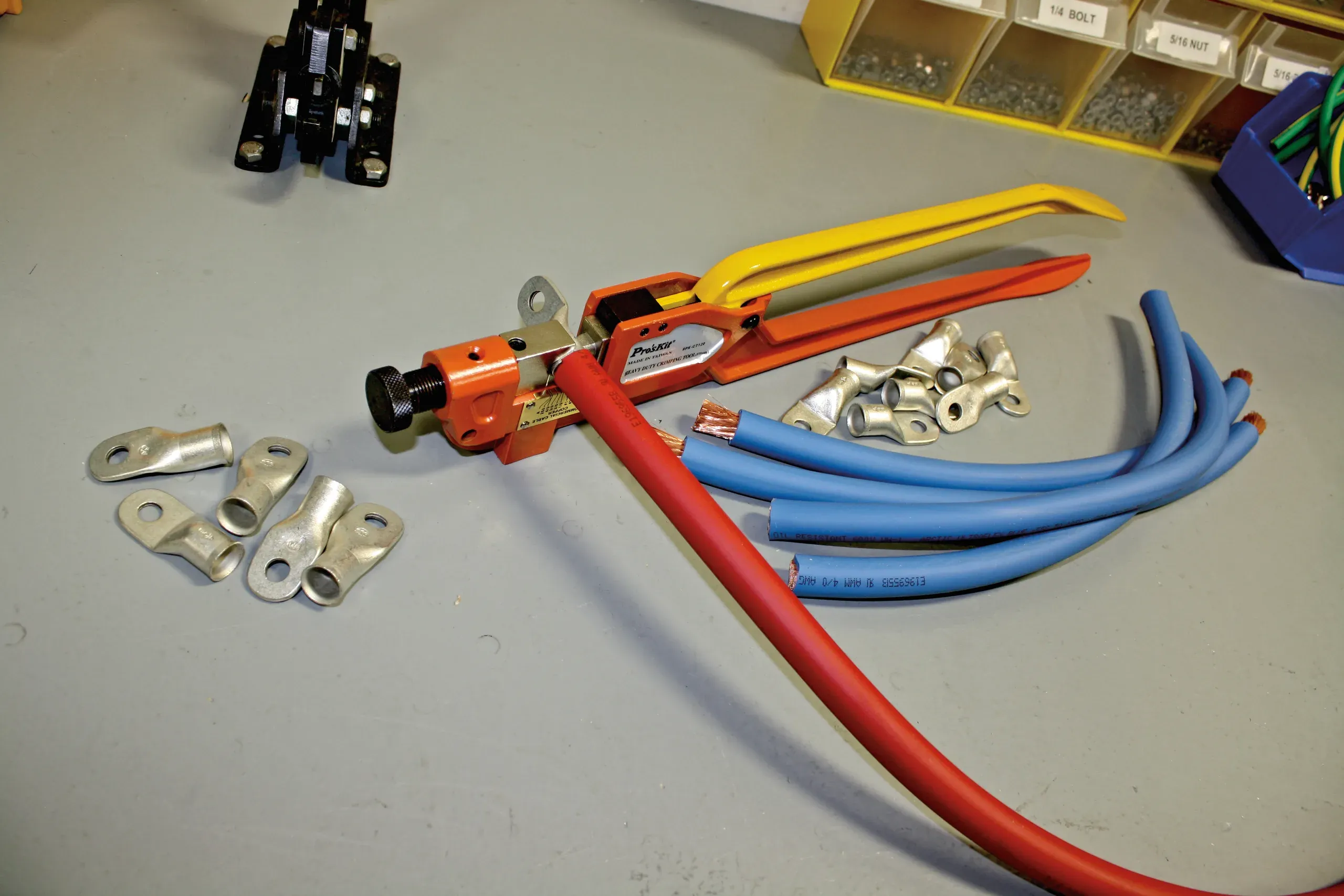 Crimp tools on the bench with cable and lugs